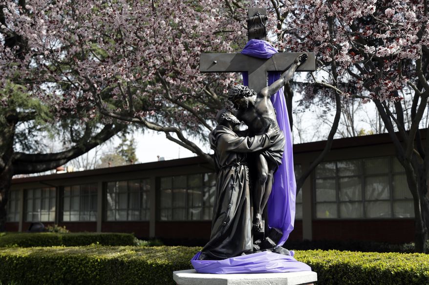 A statue decorates the entrance at St. Francis High School Friday, March 3, 2017, in Mountain View, Calif. The red-hot IPO debut of vanishing-photo superstar Snap this week not only placed the Southern California startup at a $35 billion value. It also made Mountain View, Calif.'s Saint Francis high school $23 million richer. The Catholic school had invested $15,000 in Snap's early round of funding way back in 2012. By the time shares in Snap had finished trading Thursday afternoon, that pittance had turned into a big fat pile of shareholder value. (AP Photo/Marcio Jose Sanchez)