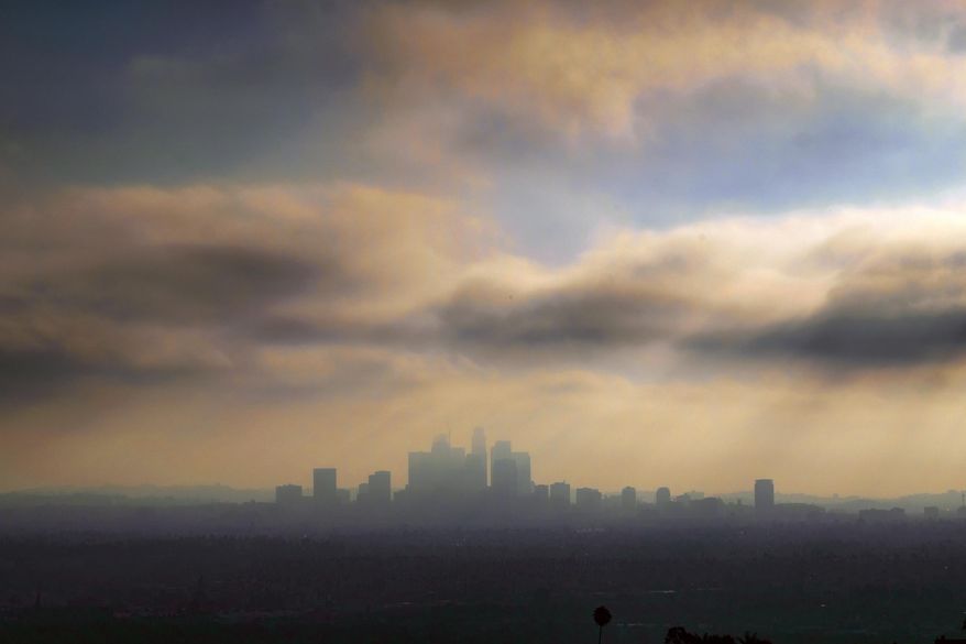 FILE - In this Aug. 12, 2016 file photo, downtown Los Angeles is shrouded in early morning coastal fog. A long-term plan for cleaning up the air in a huge swath of smoggy Southern California is due for consideration by regulators. Directors of the South Coast Air Quality Management District are expected to vote on the plan Friday, March 3, 2017. (AP Photo/Richard Vogel, File)