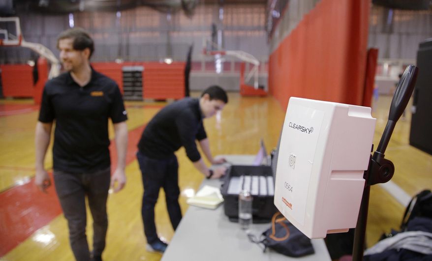 A wireless receiver, right, collects data from tracking devices worn by basketball players as Catapult monitoring system employees monitor the game and its players data Friday, March 3, 2017, in Cambridge, Mass. Athlete trackers are being used by hundreds of teams in dozens of sports helping coaches plan their practices, make substitutions in games and decide when a player is ready to return from an injury by accumulating biometric and positioning data collected from the trackers. (AP Photo/Stephan Savoia)