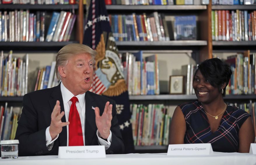 Saint Andrew Catholic School principal Latrina Peters-Gipson listens at right as President Donald Trump speaks during a round table discussion at the school, Friday, March 3, 2017, in Orlando, Fla. (AP Photo/Alex Brandon)