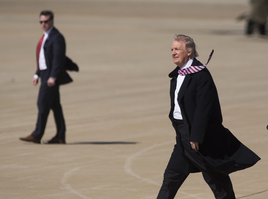 President Donald Trump walks across the tarmac at Langley Air Force Base in Hampton, Va., Thursday, March 2, 2017 after arriving on Air Force One for his first visit to the Hampton Roads area since taking office in January. The purpose of his visit was to deliver a speech in the hangar bay of the aircraft carrier Ford at Newport News Shipbuilding. (Bill Tiernan/The Virginian-Pilot via AP)