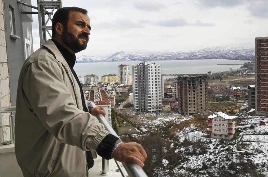 In this Friday, Feb. 17, 2017 photo, Suleiman Herwis, 50, a Libyan national, who lives in Riyadh, Saudi Arabia, stands on the balcony of his recently purchased flat, in the Black Sea region town of Fatsa, Turkey. The Saudi Arabia-based physician says he is looking forward to vacations in this remote but more conservative part of Turkey, an area largely bypassed by Western tourists. (AP Photo/Neyran Elden)