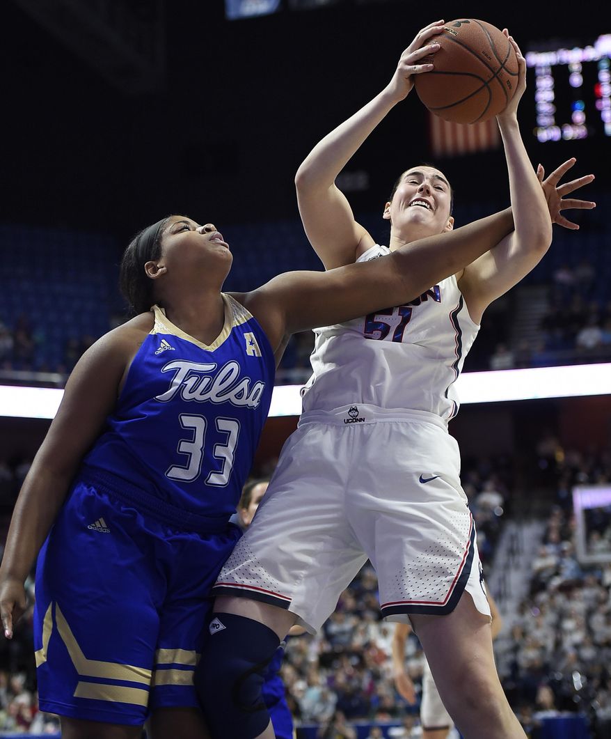 Connecticut&#39;s Natalie Butler, right, keeps the ball from Tulsa&#39;s Crystal Polk, left, during the first half of an NCAA college basketball game in the American Athletic Conference tournament quarterfinals at Mohegan Sun Arena, Saturday, March 4, 2017, in Uncasville, Conn. (AP Photo/Jessica Hill)
