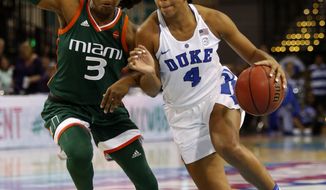 Duke&#x27;s Lexie Brown, right, drives the ball by Miami&#x27;s Jessica Thomas, left, during the first half of an NCAA college basketball game in the Atlantic Coast Conference tournament at the HTC Center in Conway, S.C., Saturday, March 4, 2017. (AP Photo/Mic Smith)