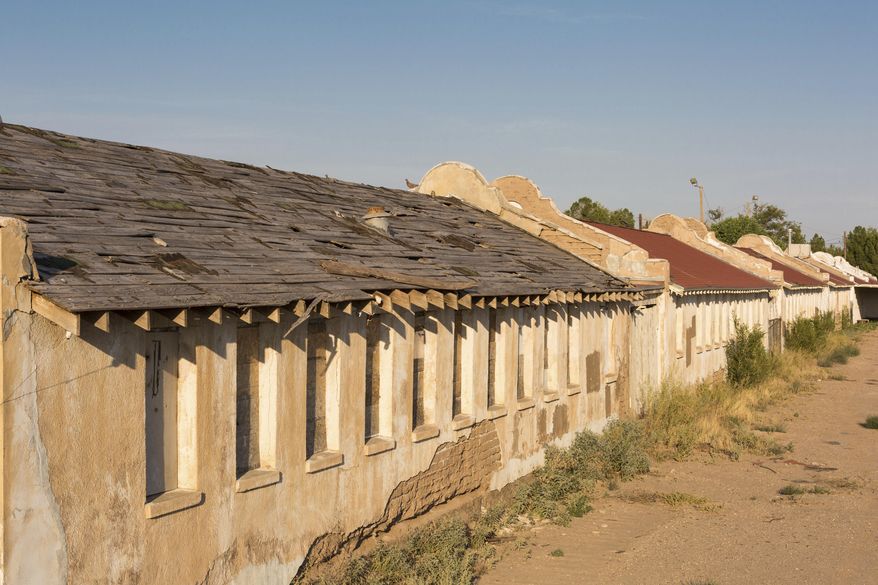 This undated photo provided by the National Trust for Historic Preservation shows a building in the historic Rio Vista Farm in Socorro, Texas. The adobe structure shows deterioration that is evident throughout the entire complex. The Texas border town is working to restore crumbling white adobe buildings that were once a processing site for millions of Mexicans who came to the U.S. as temporary guest workers for more than two decades starting in World War II. Local officials and preservationists want to create a site that will tell the stories of the “braceros” who worked on farms and railroads. (National Trust for Historic Preservation via AP)