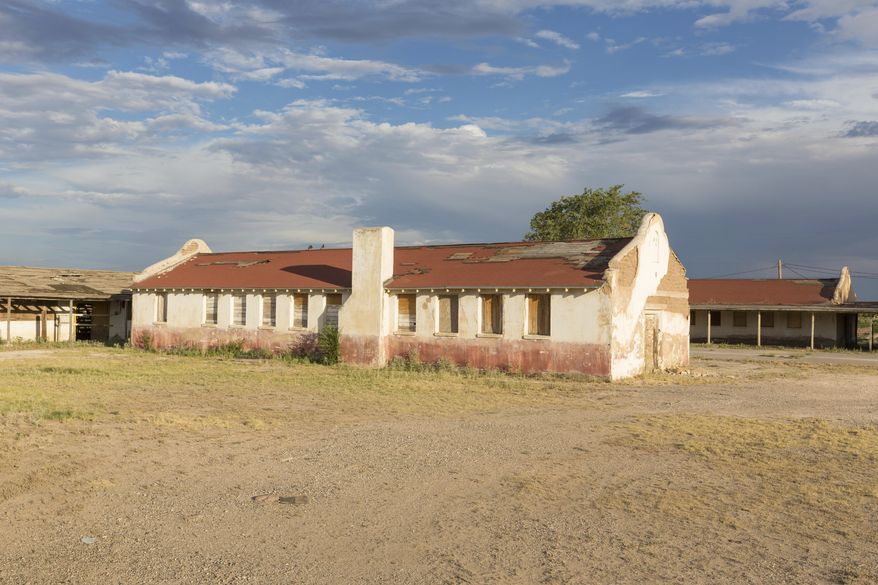 This undated photo provided by the National Trust for Historic Preservation shows a building in the historic Rio Vista Farm in Socorro, Texas. The center adobe structure built in 1935 was once the recreation hall for the County Poor Farm. The Texas border town is working to restore crumbling white adobe buildings that were once a processing site for millions of Mexicans who came to the U.S. as temporary guest workers for more than two decades starting in World War II. Local officials and preservationists want to create a site that will tell the stories of the “braceros” who worked on farms and railroads. (National Trust for Historic Preservation via AP)