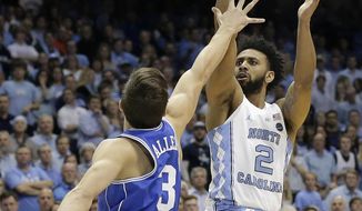 North Carolina&#x27;s Joel Berry II (2) shoots over Duke&#x27;s Grayson Allen (3) during the first half of an NCAA college basketball game in Chapel Hill, N.C., Saturday, March 4, 2017. (AP Photo/Gerry Broome)