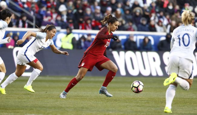 United States midfielder Carli Lloyd, center, moves the ball upfield against England during the first half of a SheBelieves Cup women&#x27;s soccer match, Saturday, March 4, 2017, in Harrison, N.J. (AP Photo/Julio Cortez)