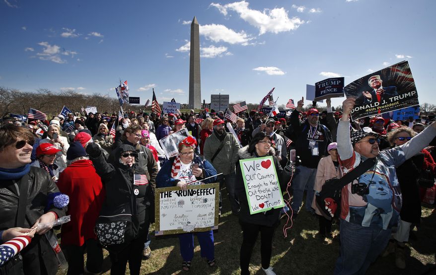 Supporters of President Donald Trump, cheer at the National Mall near the Washington Monument in Washington during a rally organized by the North Carolina-based group Gays for Trump, Saturday, March 4, 2017. The speakers at the rally talked about immigration, gay rights, and several other issues and later marched from the National Mall to the White House. (AP Photo/Manuel Balce Ceneta)