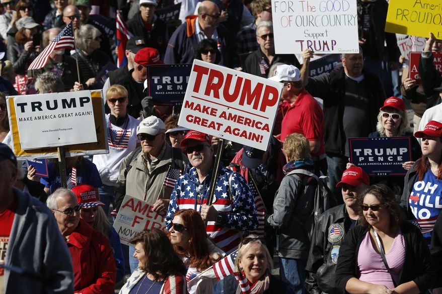Supporters of President Donald Trump gather during a March 4 Trump rally on the state Capitol steps in Denver, Saturday, March 4, 2017. (AP Photo/Brennan Linsley)