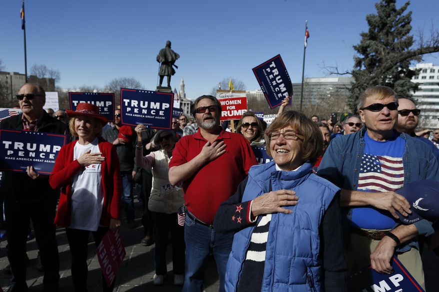 Supporters of President Donald Trump gather during a March 4 Trump rally on the state Capitol steps in Denver, Saturday, March 4, 2017. (AP Photo/Brennan Linsley)