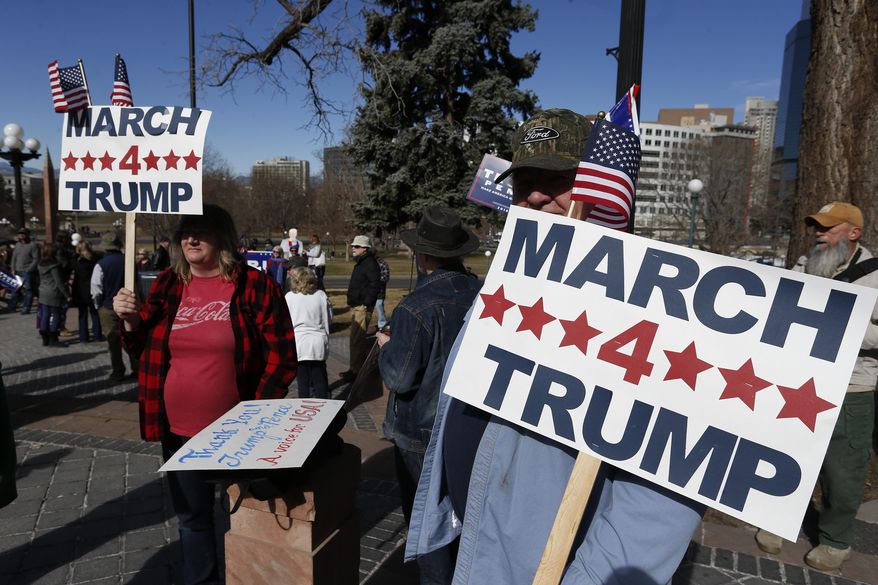Supporters of President Donald Trump gather during a March 4 Trump rally on the state Capitol steps in Denver, Saturday, March 4, 2017. (AP Photo/Brennan Linsley)