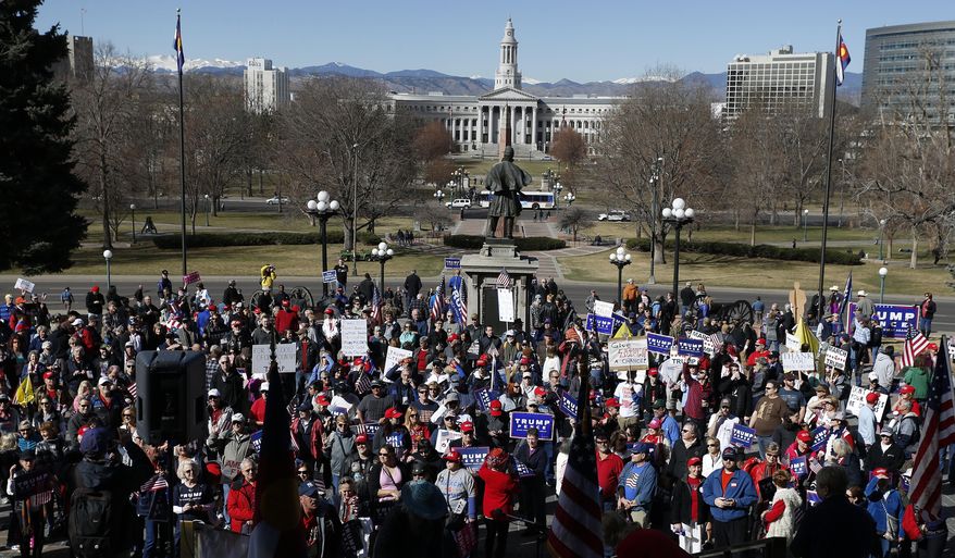 Supporters of President Donald Trump gather during a March 4 Trump rally on the state Capitol steps in Denver, Saturday, March 4, 2017. (AP Photo/Brennan Linsley)