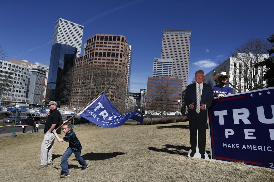 Supporters of President Donald Trump gather during a March 4 Trump rally on the state Capitol steps in Denver, Saturday, March 4, 2017. (AP Photo/Brennan Linsley)