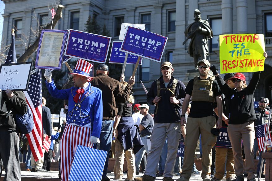 Supporters of President Donald Trump gather during a March 4 Trump rally on the state Capitol steps in Denver, Saturday, March 4, 2017. (AP Photo/Brennan Linsley)