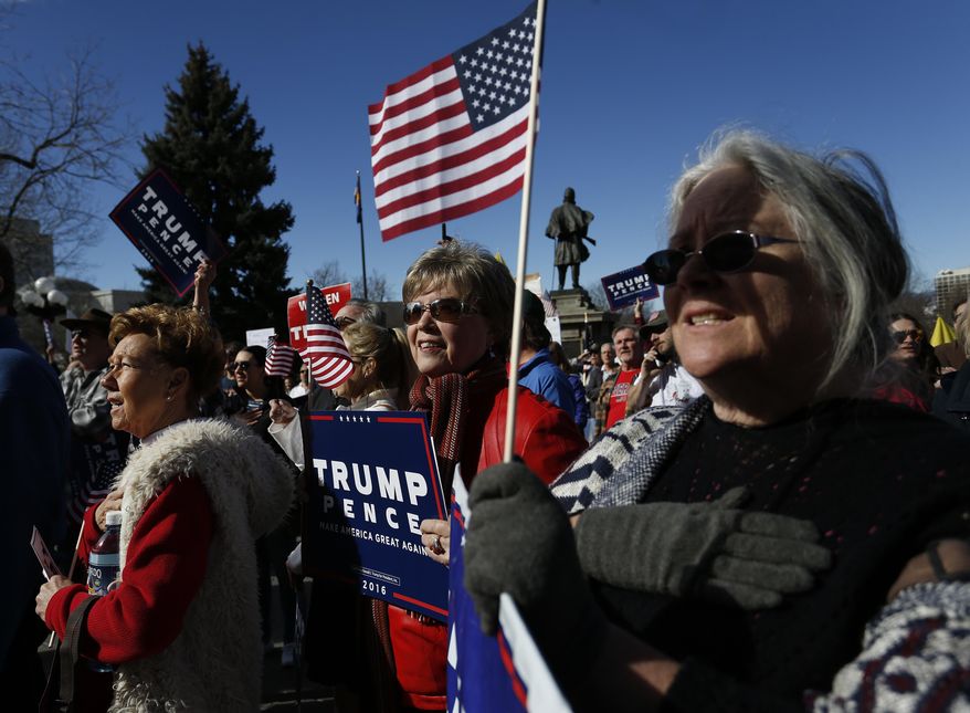 Supporters of President Donald Trump gather during a March 4 Trump rally on the state Capitol steps in Denver, Saturday, March 4, 2017. (AP Photo/Brennan Linsley)