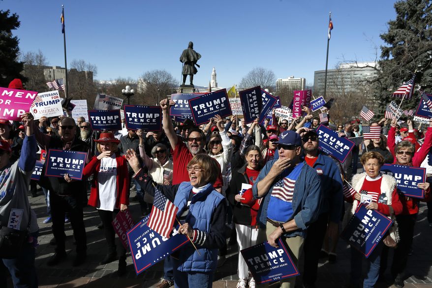 Supporters of President Donald Trump gather during a March 4 Trump rally on the state Capitol steps in Denver, Saturday, March 4, 2017. (AP Photo/Brennan Linsley)