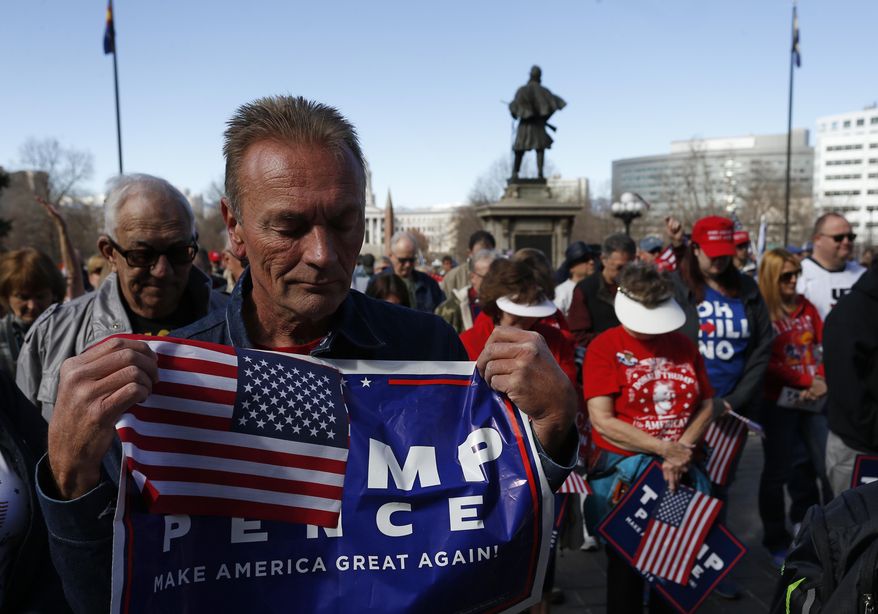 Supporters of President Donald Trump pray during a March 4 Trump rally on the state Capitol steps in Denver, Saturday, March 4, 2017. (AP Photo/Brennan Linsley)