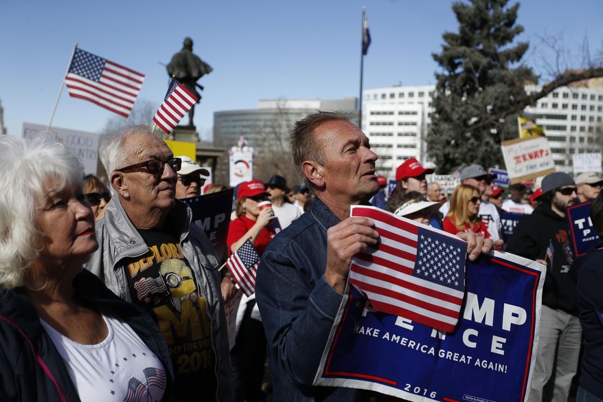 Supporters of President Donald Trump gather during a March 4 Trump rally on the state Capitol steps in Denver, Saturday, March 4, 2017. (AP Photo/Brennan Linsley)