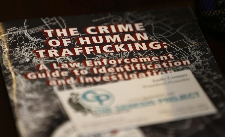 In this file photo taken Feb. 27, 2017, a law-enforcement guide to human trafficking sits on a table at The Genesis Project, a drop-in center for victims of sex trafficking in SeaTac, Wash. A measure passed last week in the Washington state Senate could rewrite current law to make it easier for victims of trafficking to vacate prostitution convictions. (AP Photo/Ted S. Warren) **FILE**