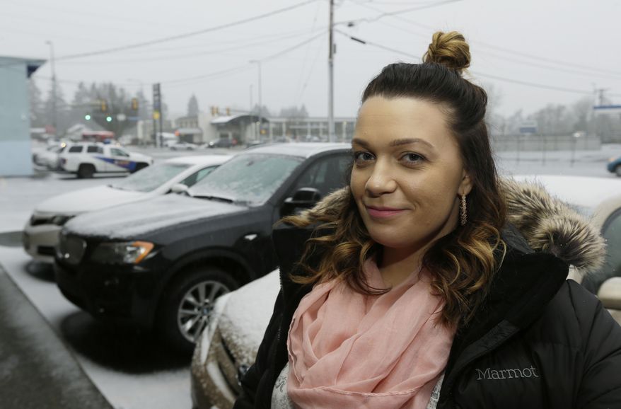 In this photo taken Feb. 27, 2017, Jessica Wolfe poses for a photo in the doorway of The Genesis Project, a drop-in center for victims of sex trafficking in SeaTac, Wash. Wolfe, who was forced into sex trafficking shortly after her 19th birthday is now struggling to find housing and a job after background checks find her prostitution convictions, but a measure passed last week in the Washington state Senate could rewrite current law to make it easier for victims of trafficking to vacate prostitution convictions. (AP Photo/Ted S. Warren)