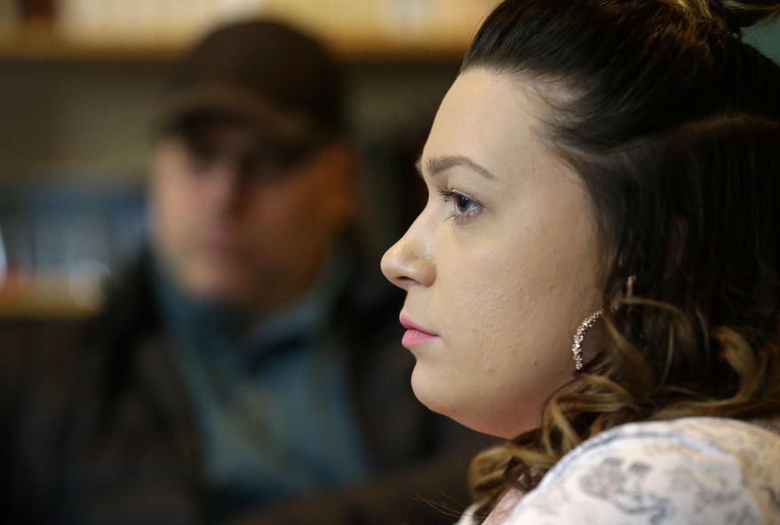 In this photo taken Feb. 27, 2017, Jessica Wolfe, right, talks about her life story as she sits at The Genesis Project, a drop-in center for victims of sex trafficking in SeaTac, Wash. with King County Sheriff's Deputy Andy Conner, left, who founded center. Wolfe, who was forced into sex trafficking shortly after her 19th birthday is now struggling to find housing and a job after background checks find her prostitution convictions, but a measure passed last week in the Washington state Senate could rewrite current law to make it easier for victims of trafficking to vacate prostitution convictions. (AP Photo/Ted S. Warren)