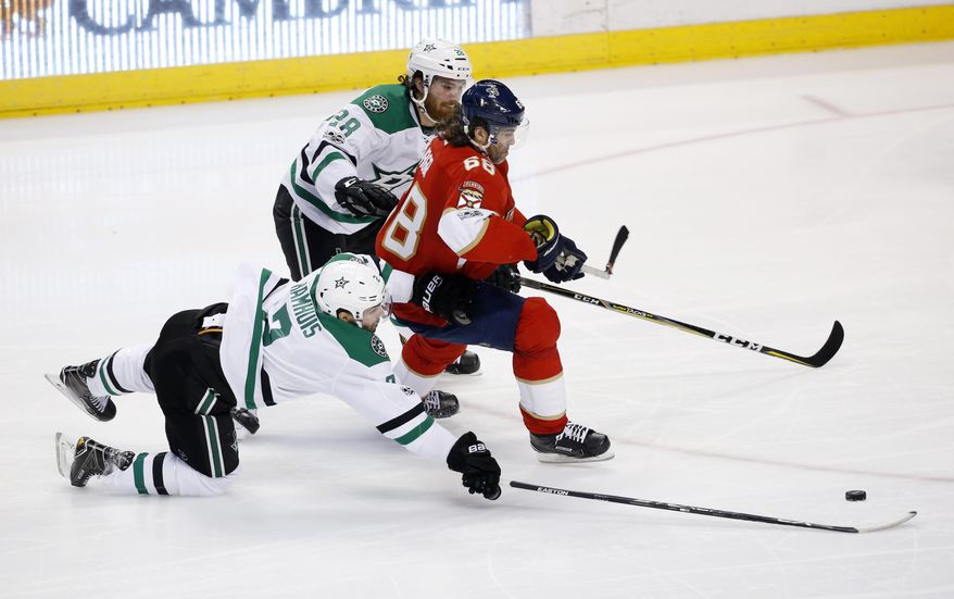 Dallas Stars defensemen Stephen Johns (28) and Dan Hamhuis (2) battle for the puck against Florida Panthers right wing Jaromir Jagr (68) during the second period of an NHL hockey game, Saturday, March 4, 2017, in Sunrise, Fla. (AP Photo/Wilfredo Lee)