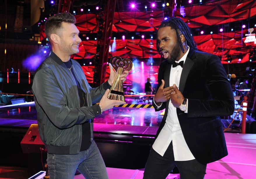 Host Ryan Seacrest, left, pretends to hand an award to singer Jason Derulo at the press preview day for the 2017 iHeartRadio Music Awards at The Forum on Thursday, March 2, 2017, in Inglewood, Calif. The annual pop music awards show will be held on Sunday at The Forum. (Photo by Chris Pizzello/Invision/AP)
