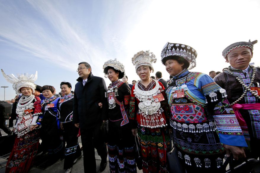 Minority delegates arrive to the Great Hall of the People to attend the opening session of the annual National People's Congress in Beijing, Sunday, March 5, 2017. China's top leadership as well as thousands of delegates from around the country are gathered at the Chinese capital for the annual legislature meetings. (AP Photo/Andy Wong)