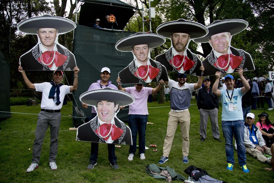 Mexican golf fans hold mariachi motif cutouts depicting from left to right; Jordan Spieth, of the U.S.; Bubba Watson, of the U.S.; Northern Ireland’s Rory McIlroy; Dustin Johnson and Phil Mickelson both of the U.S., during round three of the Mexico Championship at Chapultepec Golf Club in Mexico City, Saturday, March 4, 2017. All but one of the world's top 50 golfers are contesting the World Golf Championship PGA event, which this year relocated to Mexico City from the Trump National Doral Resort in Florida. (AP Photo/Eduardo Verdugo)