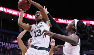 Baylor forward Nina Davis (13) shoots in front of Kansas State forward Kaylee Page, left, and teammate Beatrice Mompremier, right, in the first half of an NCAA college basketball game at the Big 12 Conference tournament in Oklahoma City, Sunday, March 5, 2017. (AP Photo/Sue Ogrocki)