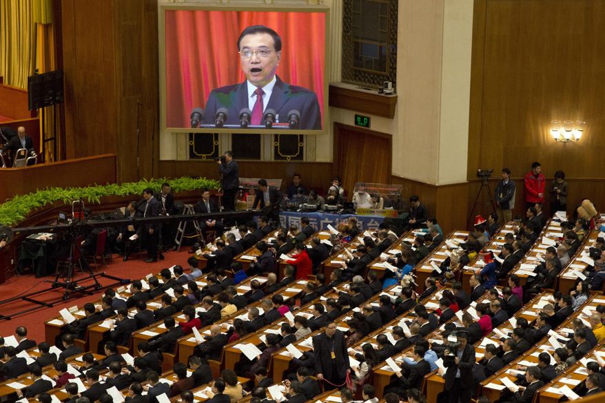 Chinese Premier Li Keqiang is displayed on a huge screen as he delivers a work report at the opening session of the annual National People's Congress at Beijing's Great Hall of the People, Sunday, March 5, 2017.China's top leadership as well as thousands of delegates from around the country are gathered at the Chinese capital for the annual legislature meetings. (AP Photo/Ng Han Guan)