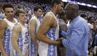 Former North Carolina basketball player Michael Jordan, right, congratulates Kennedy Meeks following North Carolina&#39;s win over Duke in an NCAA college basketball game in Chapel Hill, N.C., Saturday, March 4, 2017. (AP Photo/Gerry Broome)
