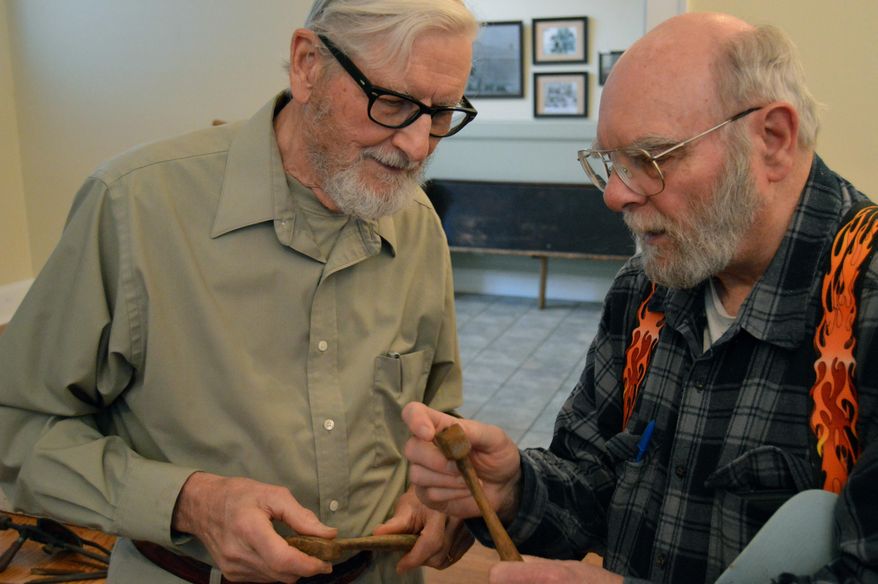 In this Feb. 28, 2017 photo David Edwards, left, of Surgoinsville, who has been carving marble since 1951, holds an antique marble carving tool he brought to share with a historical collection in Three Springs, Tenn. (Jeff Bobo /The Kingsport Times-News via AP)