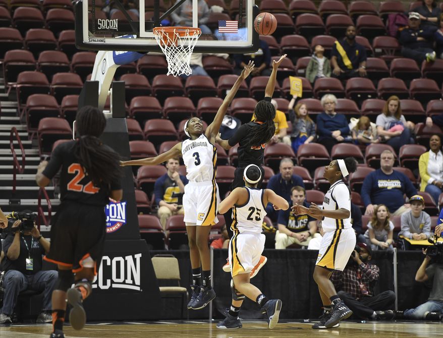 Mercer's guard KeKe Calloway (25) aims for the basket over Chattanooga's forward Jasmine Joyner (3) during the first half of an NCAA college basketball game for the Southern Conference tournament championship in Asheville, N.C., Sunday, March 5, 2017. (AP Photo/Kathy Kmonicek)