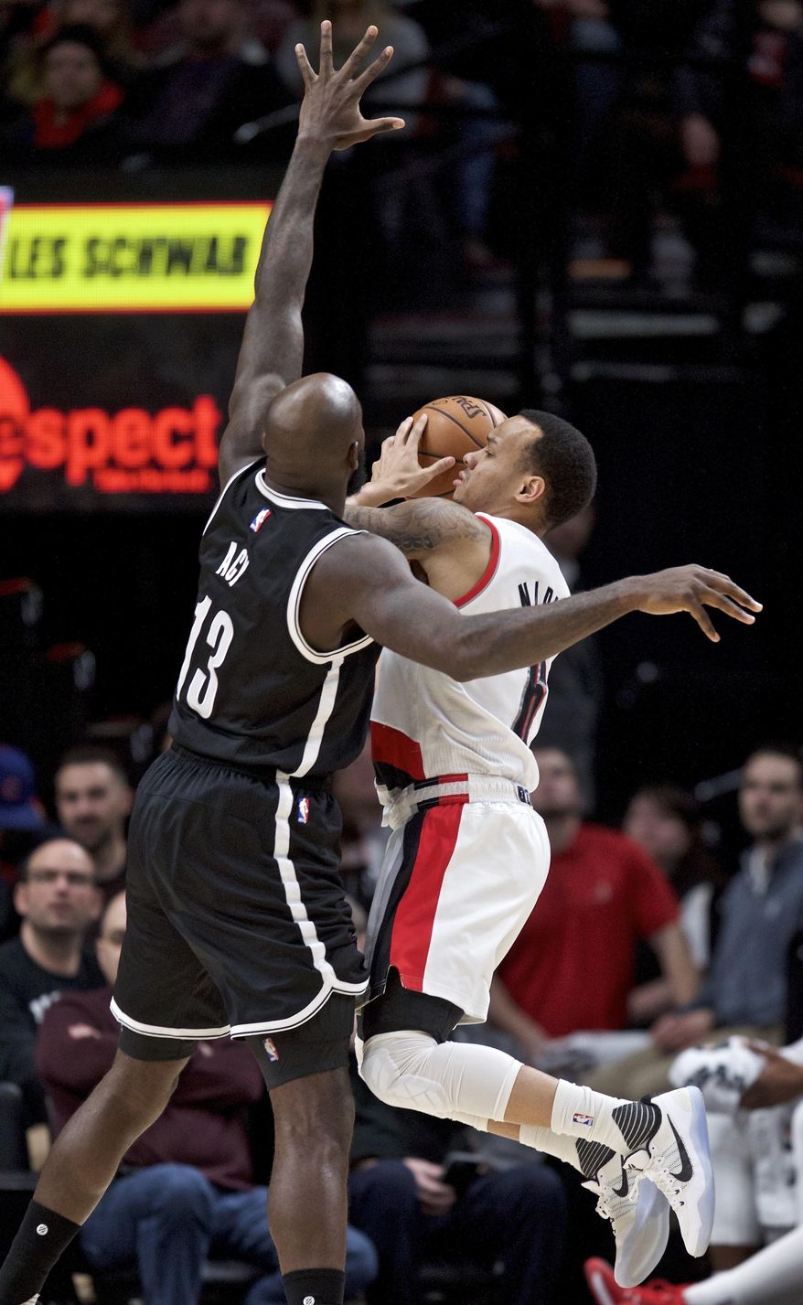 Portland Trail Blazers guard Shabazz Napier, right, shoots against Brooklyn Nets forward Quincy Acy during the second half of an NBA basketball game in Portland, Ore., Saturday, March 4, 2017. The Trail Blazers won 130-116. (AP Photo/Craig Mitchelldyer)