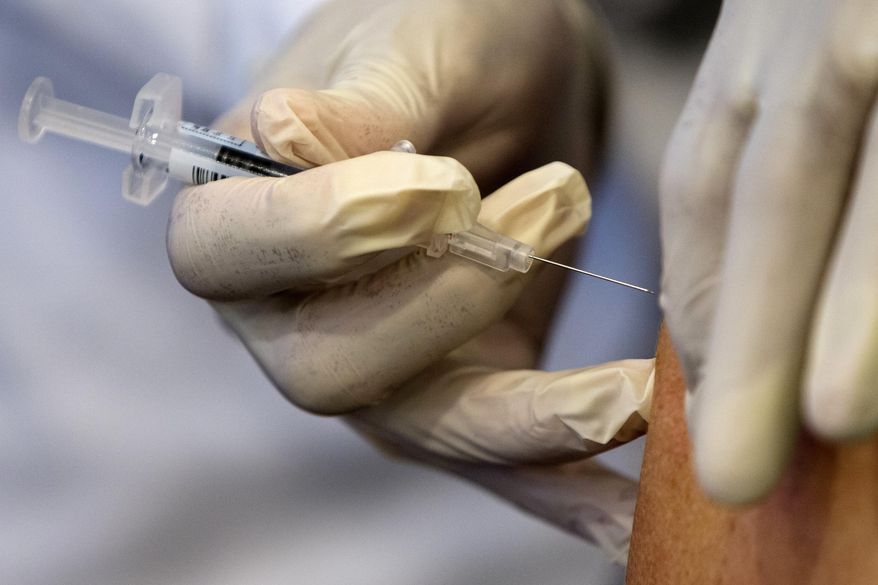 In this Thursday, Sept. 17, 2015, file photo, a nurse administers a flu vaccine shot in Washington. (AP Photo/Jacquelyn Martin, File)