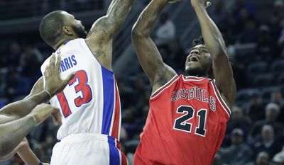Chicago Bulls forward Jimmy Butler (21), defended by Detroit Pistons forward Marcus Morris (13), shoots during the first half of an NBA basketball game, Monday, March 6, 2017, in Auburn Hills, Mich. (AP Photo/Carlos Osorio)