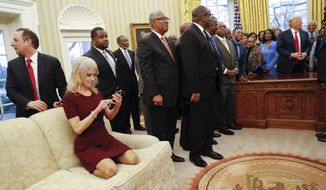 In this photo taken Feb. 27, 2017, Counselor to the President Kellyanne Conway, on couch, as President Donald Trump meets with leaders of Historically Black Colleges and Universities (HBCU) in the Oval Office of the White House in Washington. Rep. Cedric Richmond, D-La. has apologized for making a crude joke about Conway.   (AP Photo/Pablo Martinez Monsivais)