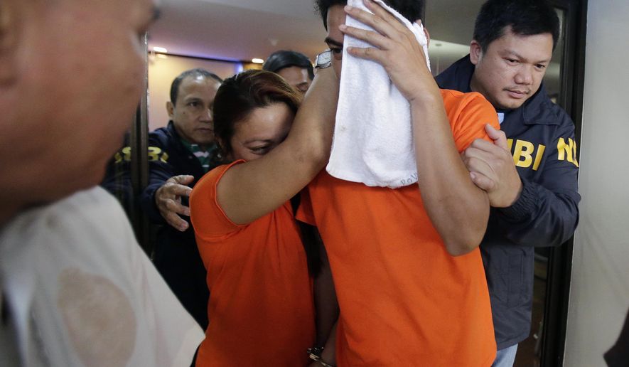 FILE - In this April 26, 2016 file photo, suspects accused of involvement in child trafficking and pornography are escorted by agents of the National Bureau of Investigation (NBI) in Manila, Philippines. "Stopping Traffic," a documentary to spotlight human trafficking and the grassroots activists trying to end it, will premiere in the Boston suburb of Belmont, Mass., on Saturday, March 11, 2017. The film features interviews with activists in Mexico, Philippines and the U.S., and comes as U.S. President Donald Trump is promising to bring the "full force and weight" of the U.S. government to combat human trafficking. (AP Photo/Aaron Favila)