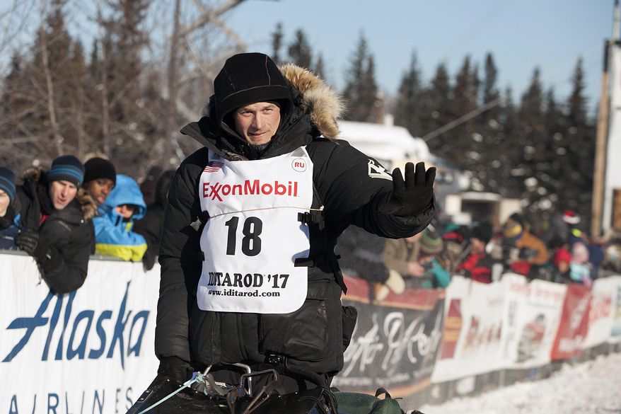Dallas Seavey, four-time Iditarod winner and reigning champion waves at the start of the 45th Iditarod Trail Sled Dog Race in Fairbanks, Alaska, Monday, March 6,2017. (AP Photo/Ellamarie Quimby)