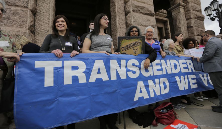 Members of the transgender community take part in a rally on the steps of the Texas Capitol, Monday, March 6, 2017, in Austin, Texas. The group is opposing a "bathroom bill" that would require people to use public bathrooms and restrooms that correspond with the sex on their birth certificate. (AP Photo/Eric Gay)