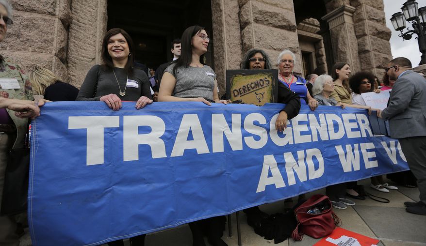 Members of the transgender community take part in a rally on the steps of the Texas Capitol, Monday, March 6, 2017, in Austin, Texas. The group is opposing a "bathroom bill" that would require people to use public bathrooms and restrooms that correspond with the sex on their birth certificate. (AP Photo/Eric Gay)