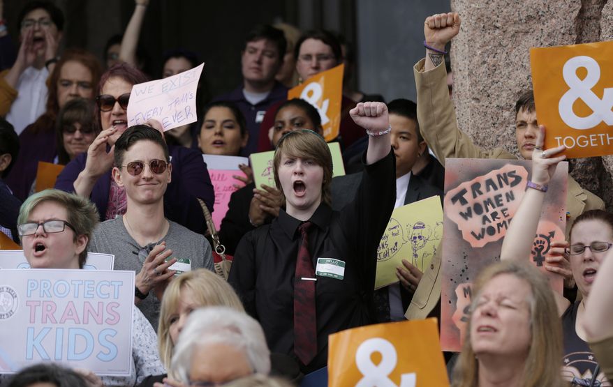 Members of the transgender community take part in a rally on the steps of the Texas Capitol, Monday, March 6, 2017, in Austin, Texas. The group is opposing a "bathroom bill" that would require people to use public bathrooms and restrooms that correspond with the sex on their birth certificate. (AP Photo/Eric Gay)