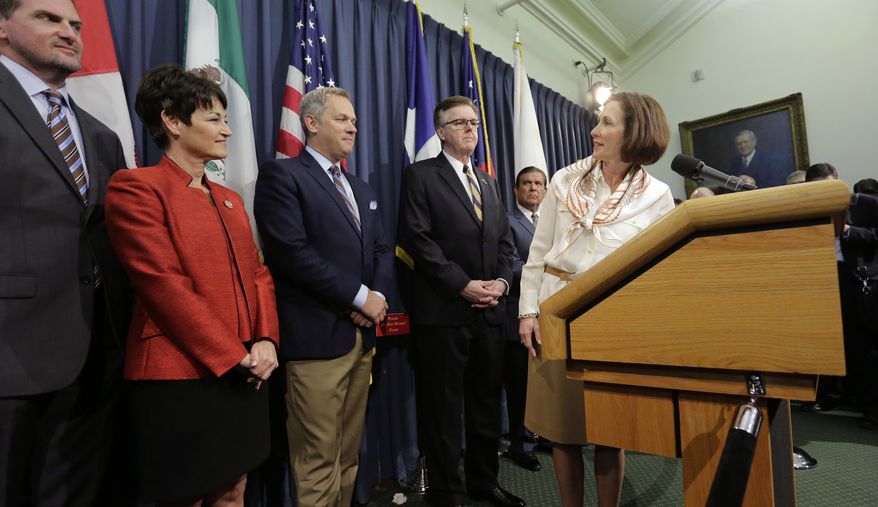 Texas Sen. Lois Kolkhorst, right, looks back at Texas Lt. Gov. Dan Patrick, center, and other legislators as they hold a news conference to discuss Senate Bill 6 at the Texas Capitol, Monday, March 6, 2017, in Austin, Texas. The "bathroom bill" would require people to use public bathrooms and restrooms that correspond with the sex on their birth certificate. (AP Photo/Eric Gay)