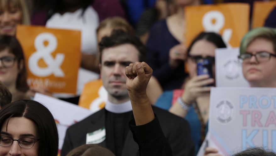 Members of the transgender community take part in a rally on the steps of the Texas Capitol, Monday, March 6, 2017, in Austin, Texas. The group is opposing a "bathroom bill" that would require people to use public bathrooms and restrooms that correspond with the sex on their birth certificate. (AP Photo/Eric Gay)