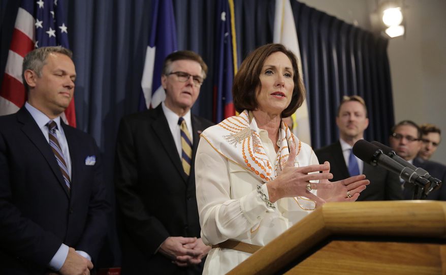 Texas Sen. Lois Kolkhorst, front, backed by Texas Lt. Gov. Dan Patrick, center, and other legislators talks to the media during a news conference to discuss Senate Bill 6 at the Texas Capitol, Monday, March 6, 2017, in Austin, Texas. The "bathroom bill" would require people to use public bathrooms and restrooms that correspond with the sex on their birth certificate. (AP Photo/Eric Gay)