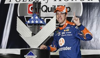 Brad Keselowski poses with the trophy in victory lane after winning a NASCAR Monster Cup series auto race at Atlanta Motor Speedway in Hampton, Ga., Sunday, March 5, 2017. (AP Photo/John Amis)