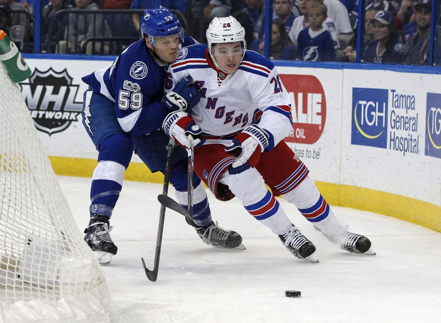 New York Rangers&#39; Jimmy Vesey avoids a check from Tampa Bay Lightning&#39;s Jake Dotchin during the first period of an NHL hockey game Monday, March 6, 2017, in Tampa, Fla. (AP Photo/Mike Carlson)