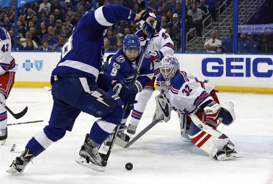 New York Rangers goalie Antti Raanta, of Finland, looks for a rebound as Tampa Bay Lightning&#39;s Tyler Johnson reaches for it during the second period of an NHL hockey game, Monday, March 6, 2017, in Tampa, Fla. (AP Photo/Mike Carlson)